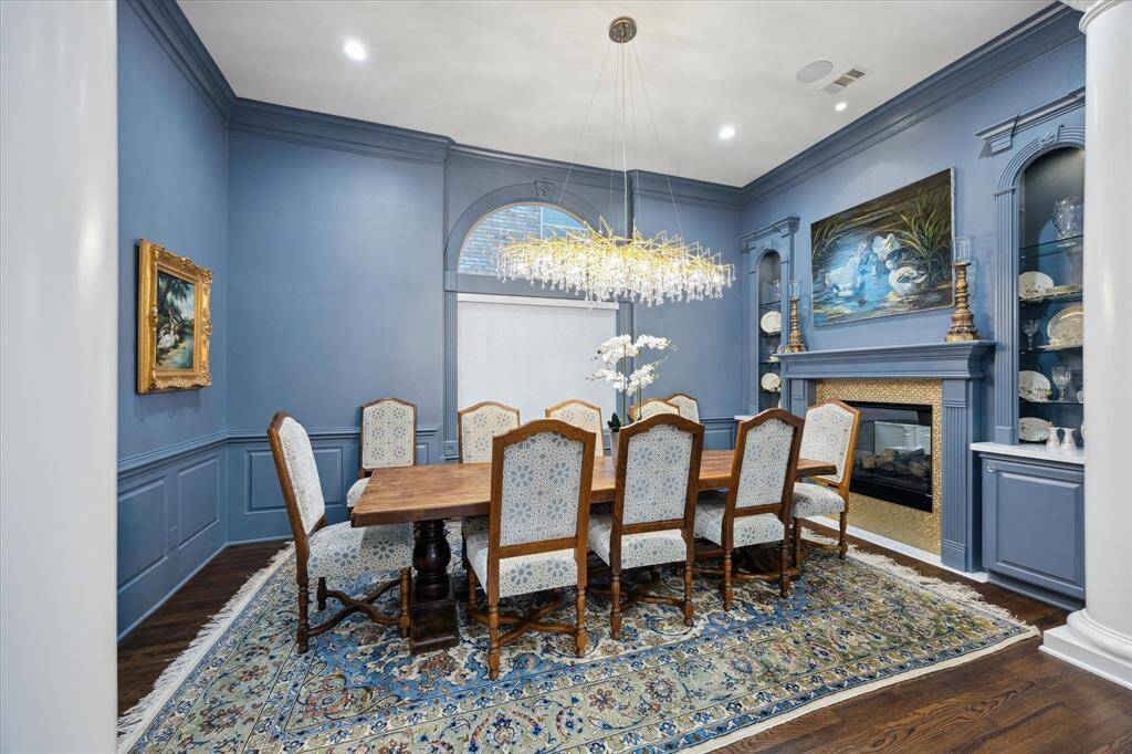 The Formal Dining Room features a fireplace, built-ins and more wood floors