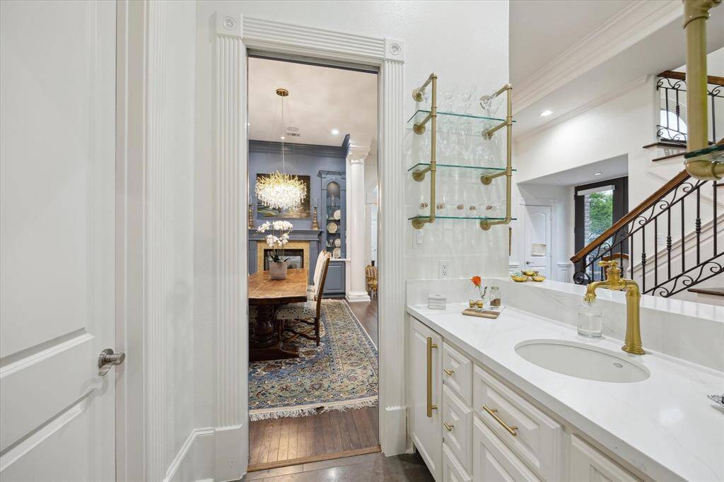 Butler's Pantry features open brass and glass shelving plus a bar sink