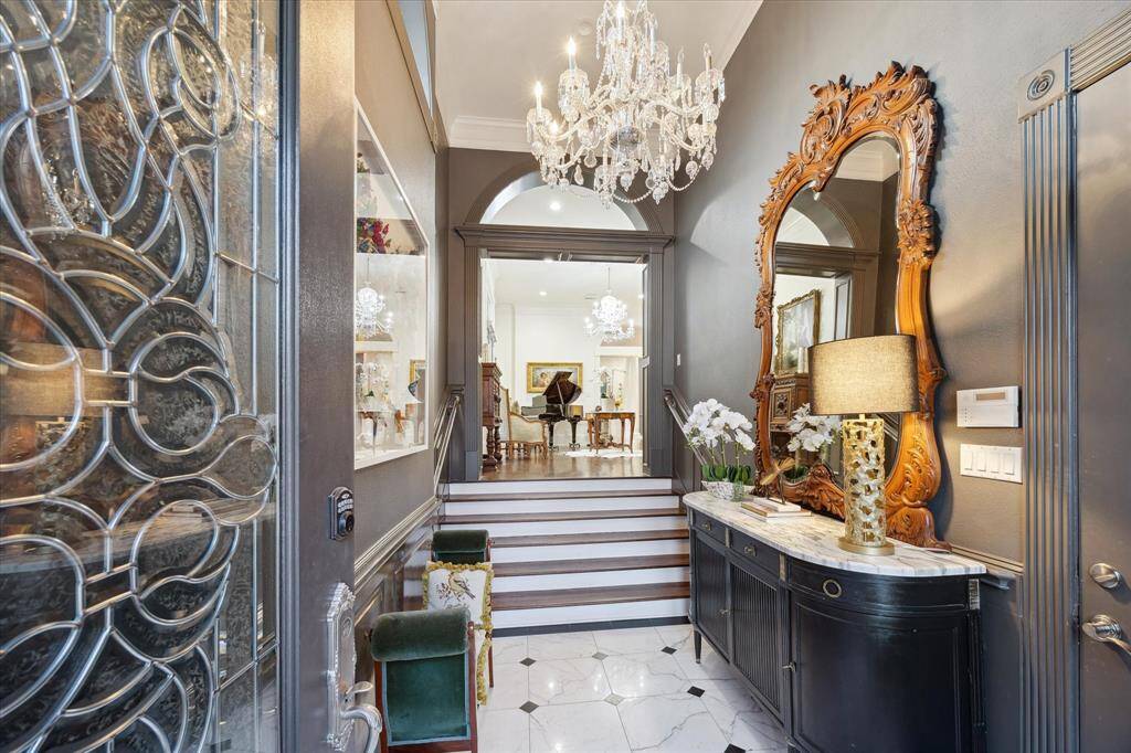Front door features an intricately designed leaded glass