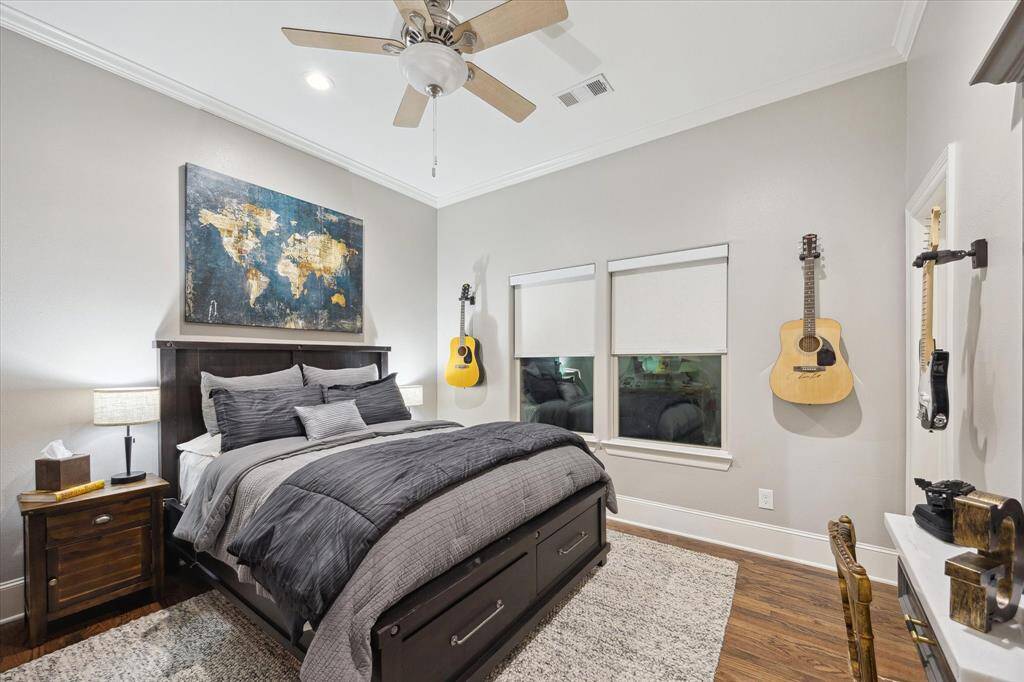 Secondary Bedroom with wood floors and a ceiling fan