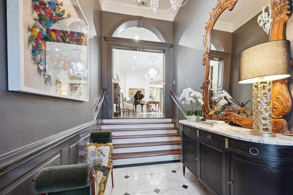 Traditional French Entry with travertine floors and a crystal chandelier