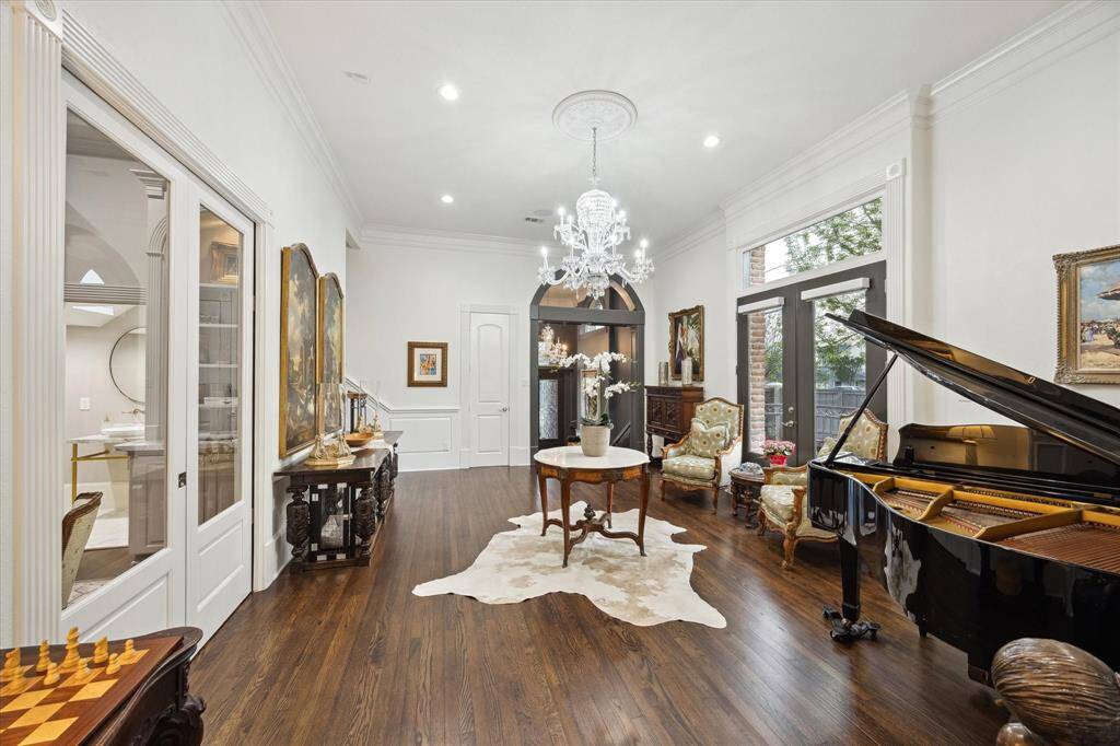 Another crystal chandelier centers the Formal Living Room and French doors lead to the Patio