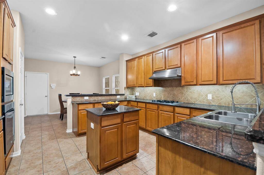 A chefs delight island kitchen with recess lights