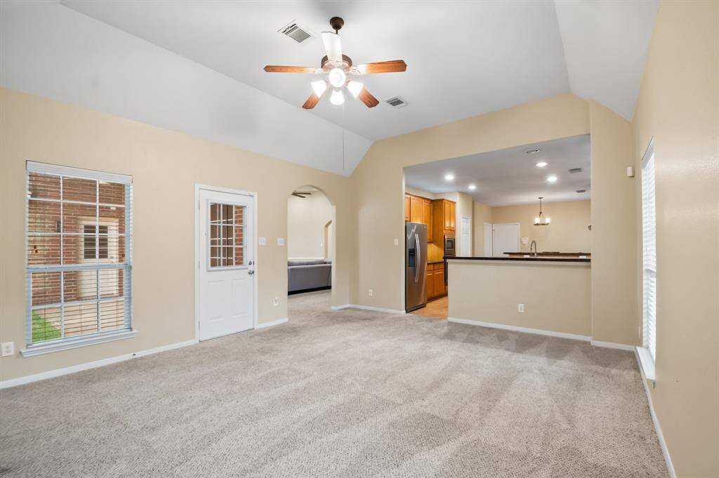 Den features a fireplace with bright lights