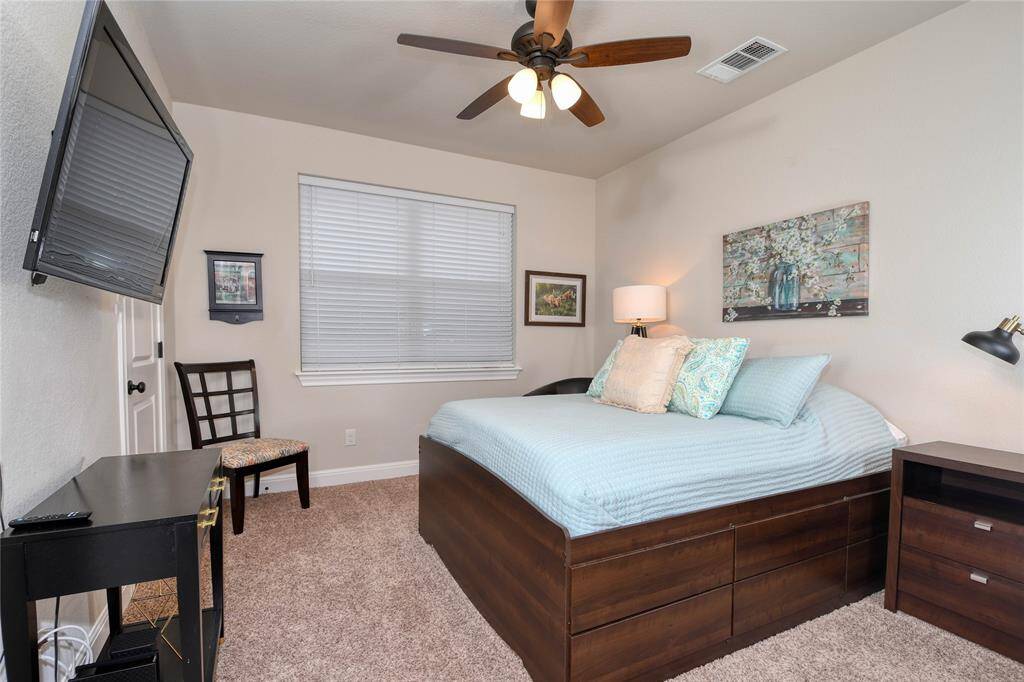 The 2nd bedroom is spacious with a view of the beautiful oaks.