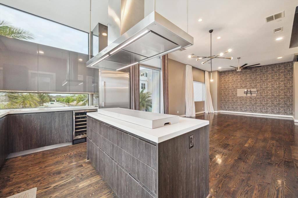 Another view of the kitchen island and beautiful natural lighting. All windows have a UV tint for privacy and heat control.
