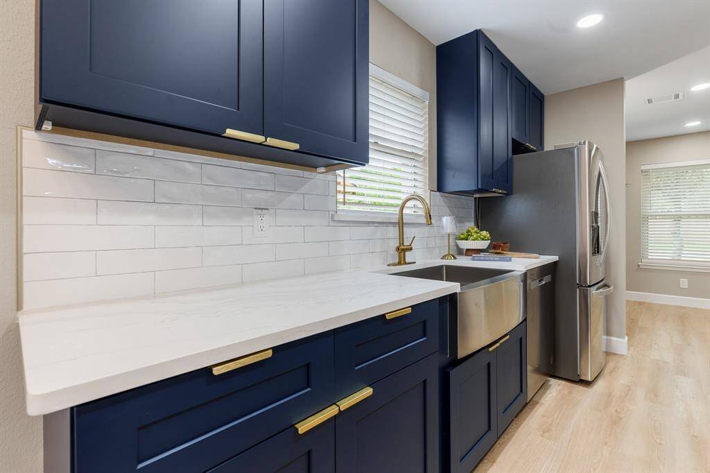 Stunning kitchen featuring elegant quartz countertops, soft-closing drawers and cabinets, new appliances, and stylish new faucets, combining luxury and practicality.