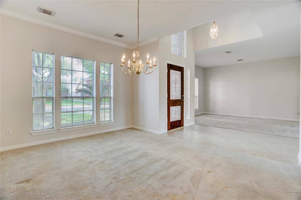 Formal dining and living room are spacious and have neutral paint colors.