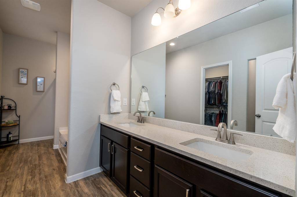 Ensuite primary bathroom has dual sinks and a large vanity.