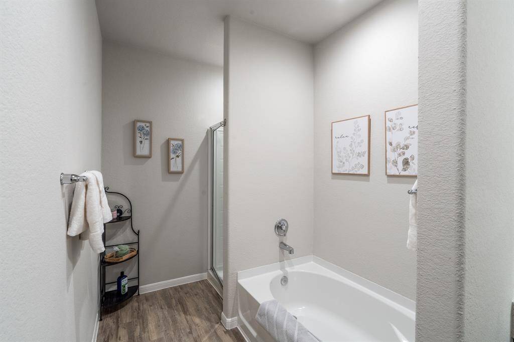 Primary bath features a separate shower & garden tub.