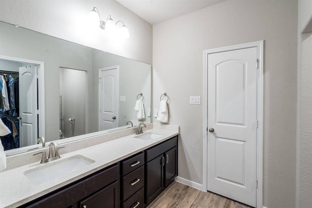Plenty of storage under the large vanity, and here's a peek of the sizable walk-in closet.