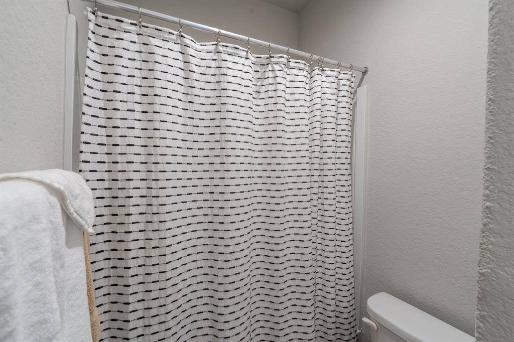 Hall bath features a tub/shower combo.