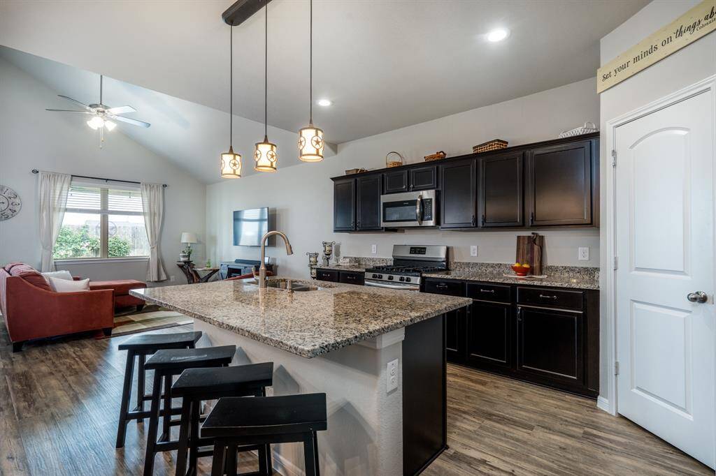 Stylish espresso stain cabinets provide ample storage, along w/ the walk-in pantry.