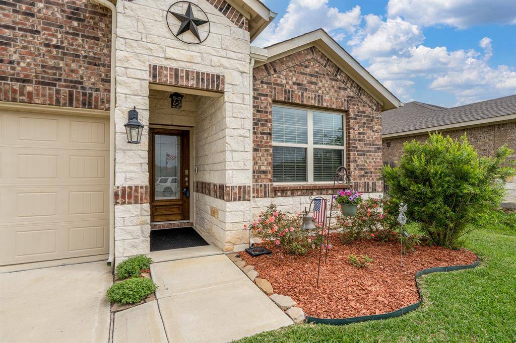 Tastefully manicured yard provides an inviting entrance.