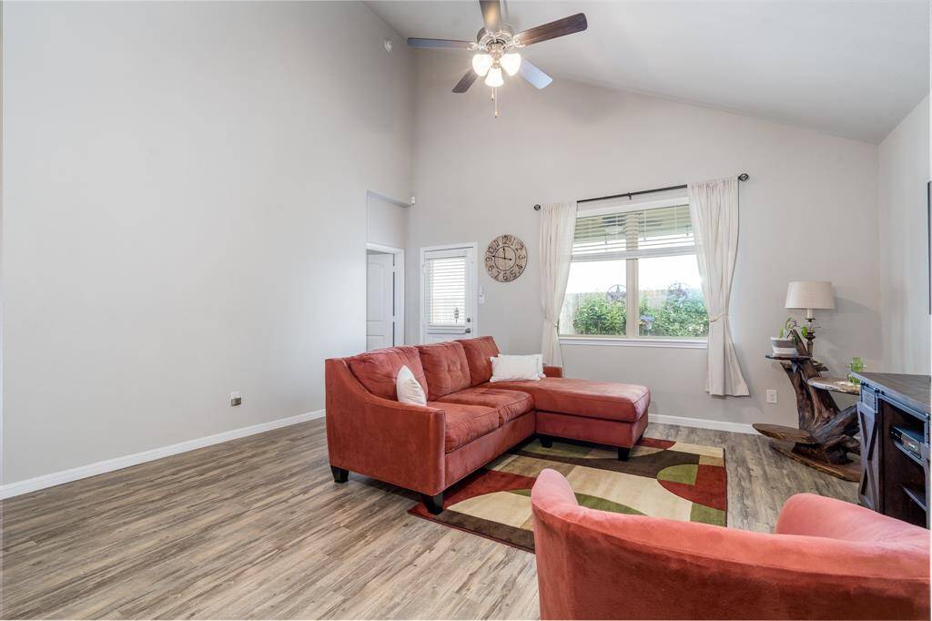 Large living room with vaulted ceilings looks out to your private backyard.