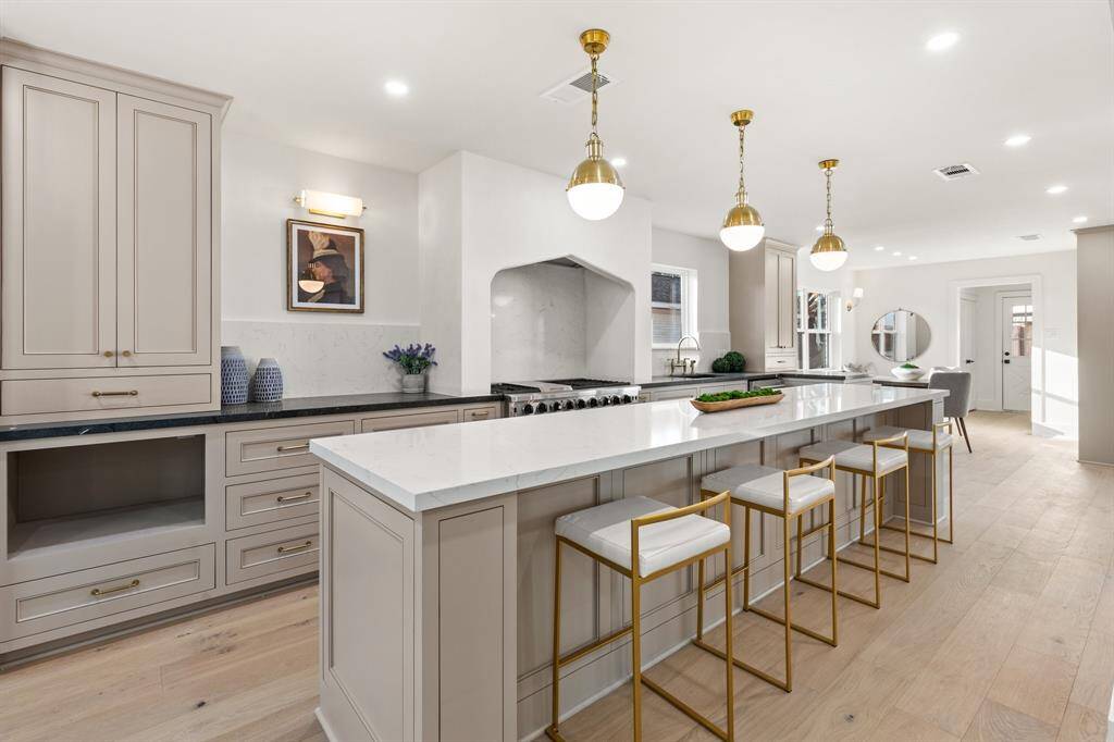 The custom cabinetry extends all the way to the ceiling. Adorned with vintage brass hardware.