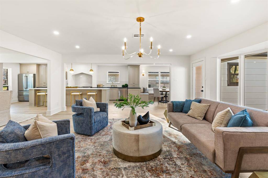 The bright, open living room showcases the homes' style. Large windows lining the room give you picturesque views of the backyard.