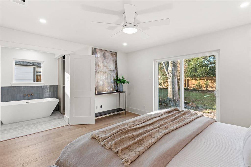 Sliding glass doors allow copious amounts of natural light to fill this room, and double doors lead you to the elegant ensuite bathroom.