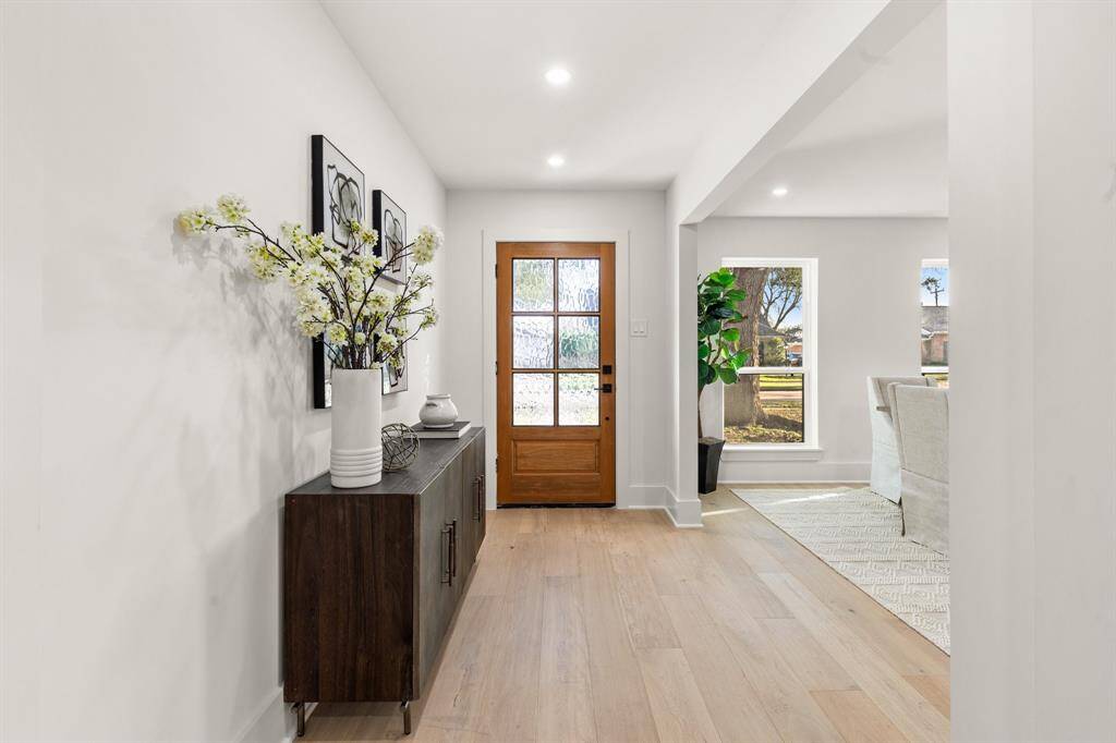 As you enter, you are greeted by a harmonious blend of modern sophistication, timeless elegance, and the warmth of European White Oak engineered hardwood flooring that flows seamlessly throughout the home.