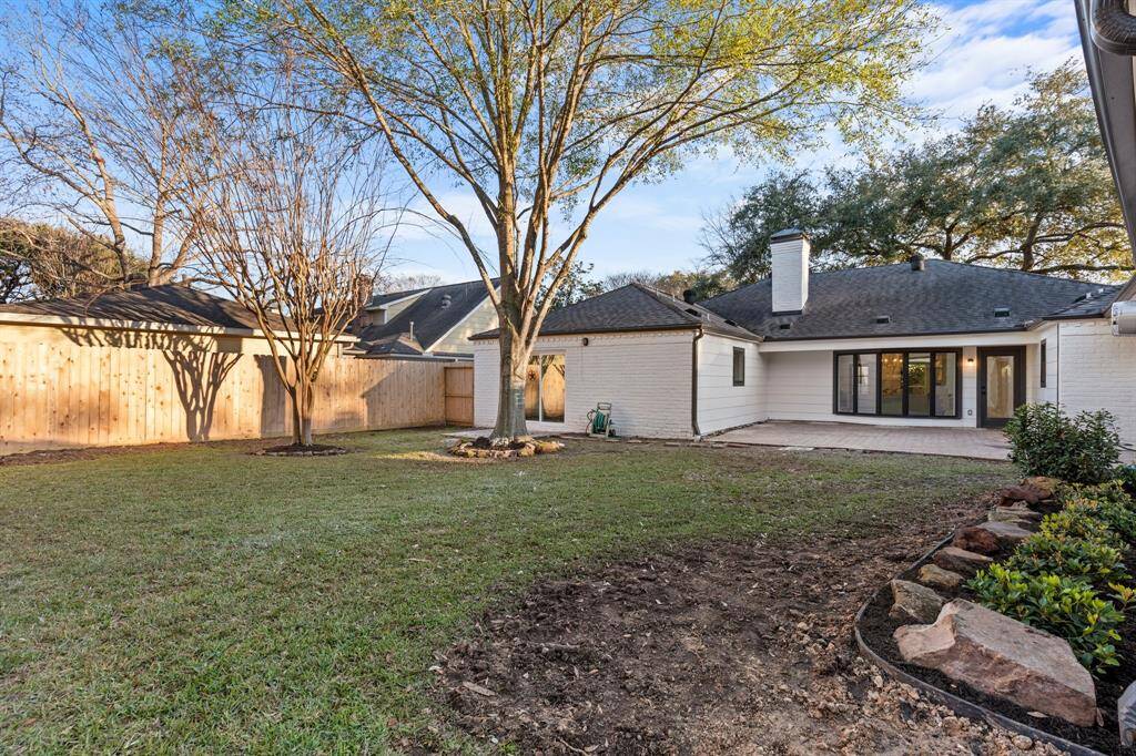 Mature trees, paved patio and ample green space make this backyard incredible!