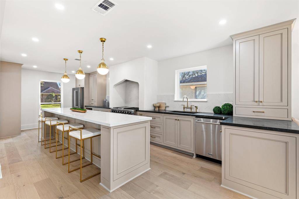 The expansive kitchen serves as the heart of the home, featuring an oversized island perfect for entertaining or hosting gatherings.