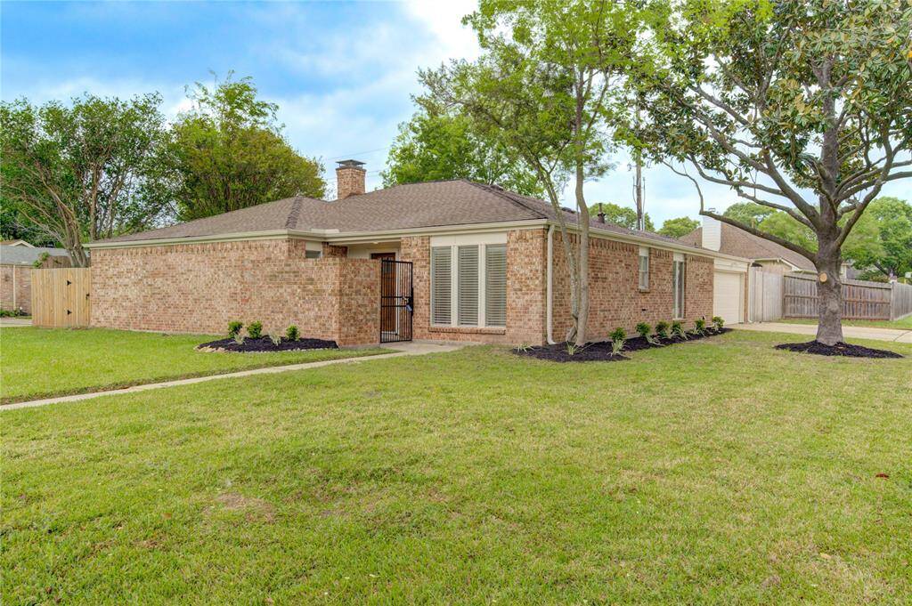 Beautiful corner lot with 7 month old roof, gutters, and fresh exterior paint!