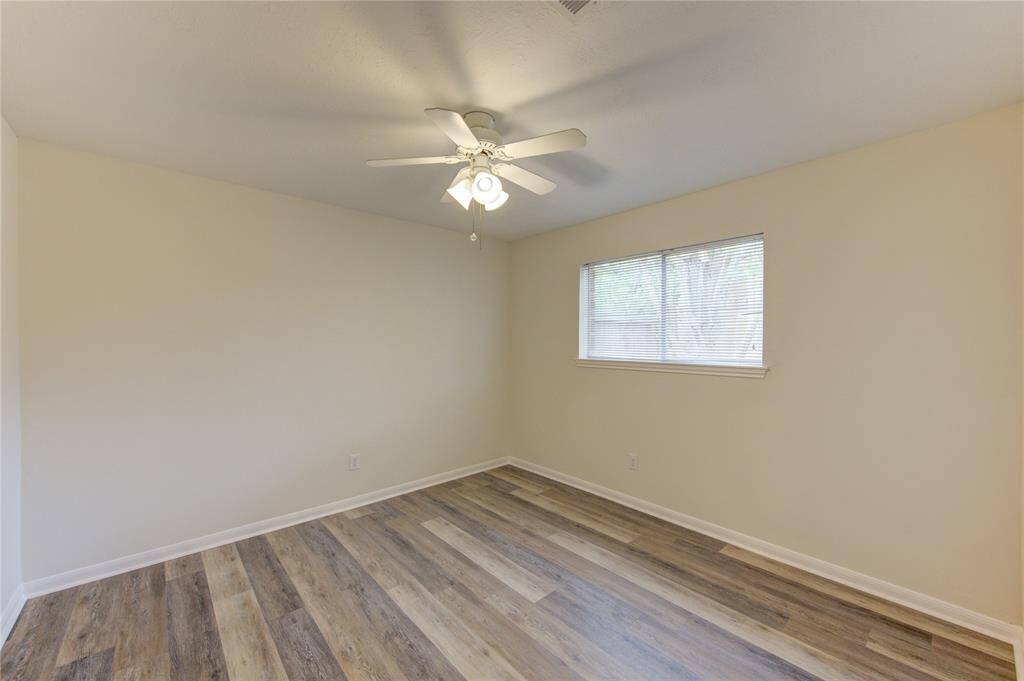 Bedroom 3.  All bedrooms have ceiling fans and window blinds.