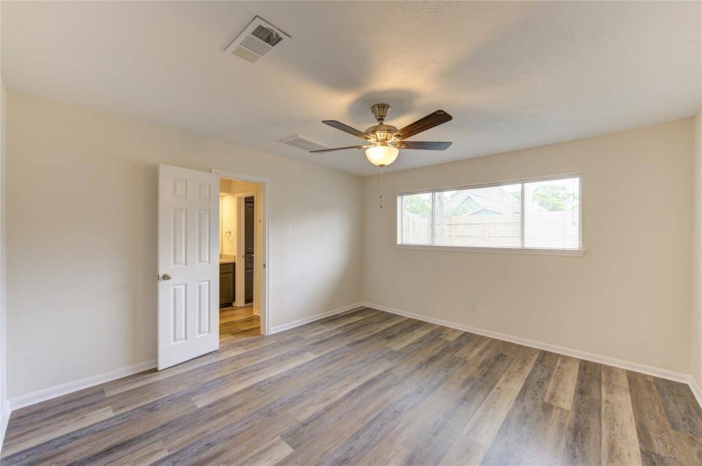 Primary badroom.  This bedroom has 2 very nice walk-in closets.  One in the main bedroom and one in the bathroom area.   All bedrooms have ceiling fans and window blinds.