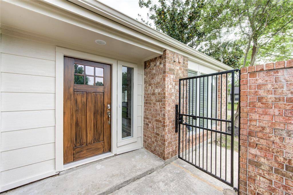 New entry door and a locking iron gate at the front entry