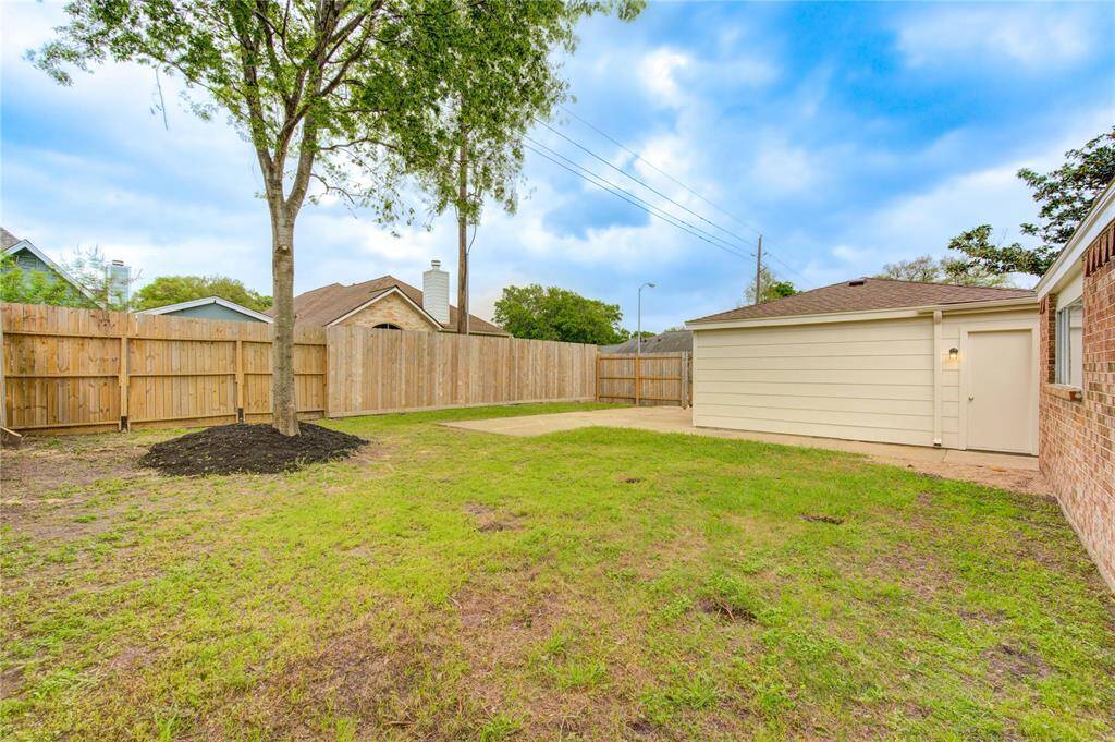 Another view of this very nice back yard.  Notice the privacy fence is 8ft tall (vs the typical 6ft fence).  The back of the garage also has a very convenient service entry door.
