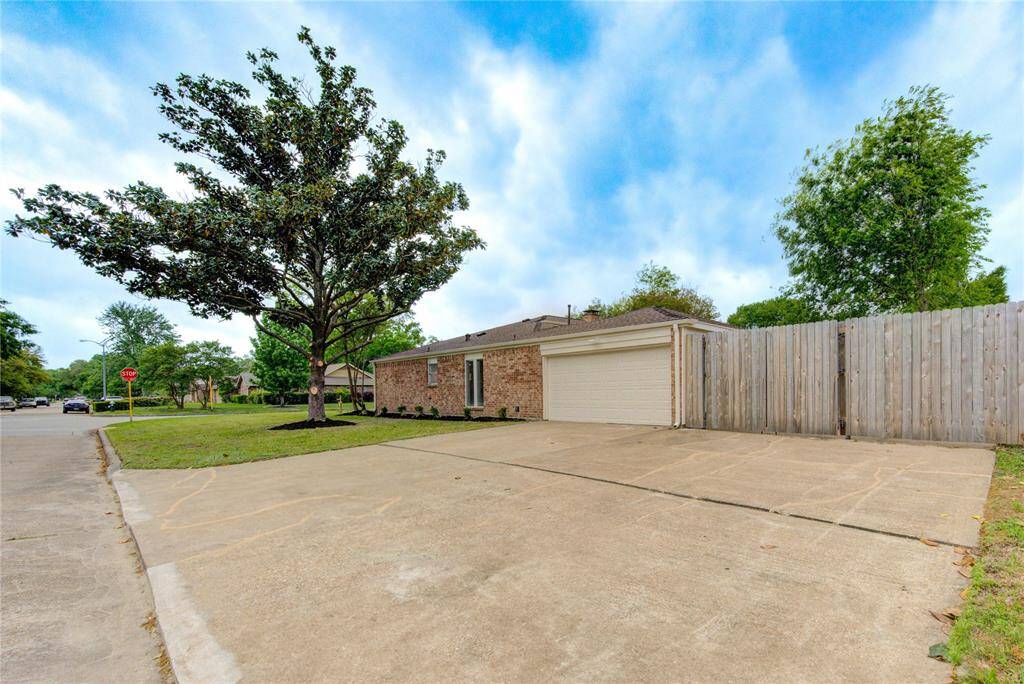 The enormous driveway has plenty of parking and a large dual gate that opens for additional concreted parking in back!