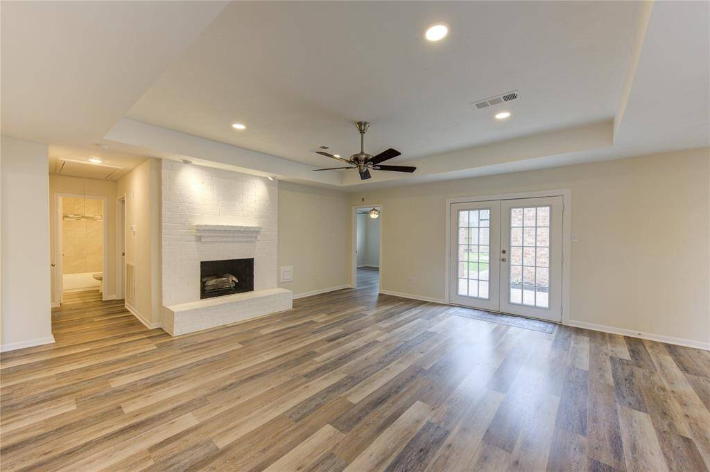 The family room is large with a raised ceiling, new LED lighting and ceiling fan, and a double French door leading to the back patio.  This is a split floor-plan with 3 bedrooms to the left and the primary bedroom to the right.   You will love the layout!