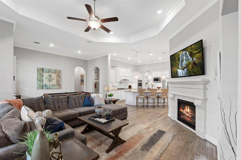 Contemporary living room with cast stone fireplace. Experience modern convenience and timeless style in this inviting living room. A striking cast stone fireplace, operable by remote, lets you effortlessly set the perfect ambiance.