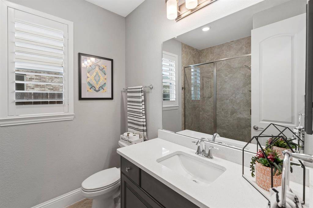 This thoughtfully positioned secondary bathroom is located right next to one of the bedrooms, thoughtfully separated from the other sleeping areas for enchanted privacy. Ideal for guests or a private retreat, this well-designed space offers both functionality and comfort.