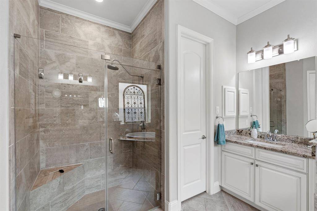 Indulge in this extra-large shower area, offering a spa-lie experience right at home. Designed for both comfort and style, this spacious primary bathroom also features elegant finishes and thoughtful details, creating the perfect retreat.