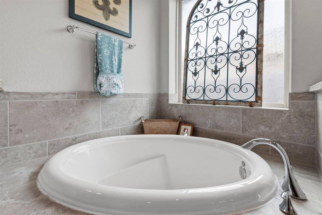 Unwind in style with a luxurious soaking tub, perfect for relaxing after a long day.