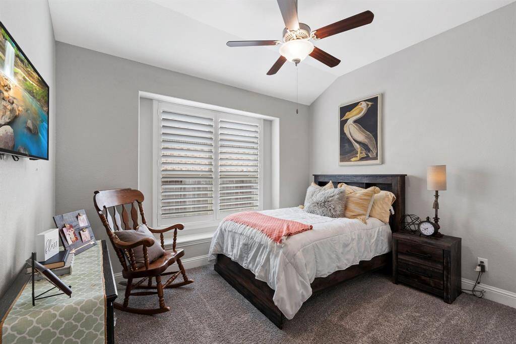Private secondary bedroom. This well-appointed secondary bedroom is conveniently located at the front of the home, offering privacy.