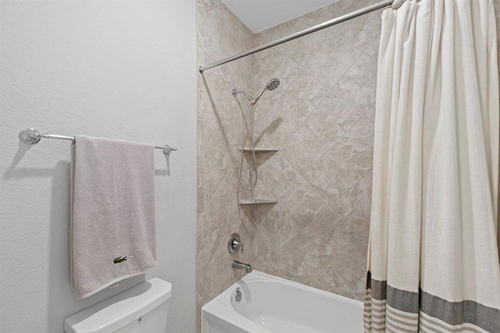 The full-size bathroom is designed for convenience, featuring a privacy door that allows one person to shower while another uses the front vanity area. With double sinks and tub-shower combo, this space is perfect for shared use without sacrificing privacy.