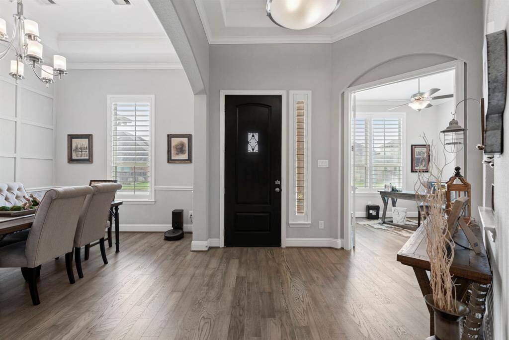 Grand entrance and elegant details! Step into a stunning larger foyer featuring double tray ceilings that add depth and sophistication to the entryway. Throughout the home, beautiful plantation shutters enhance both style and privacy, creating a timeless and elegant look.
