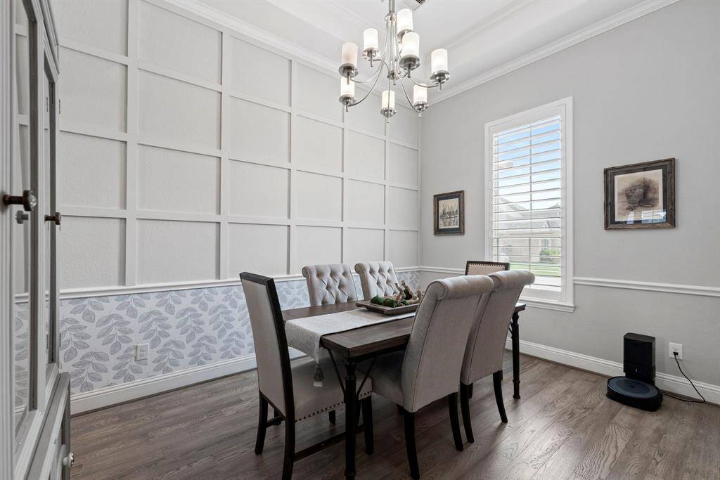 Elegant formal dining with stylish accent wall. Featuring a beautifully crafted board and batten grid accent wall that adds charm and character.