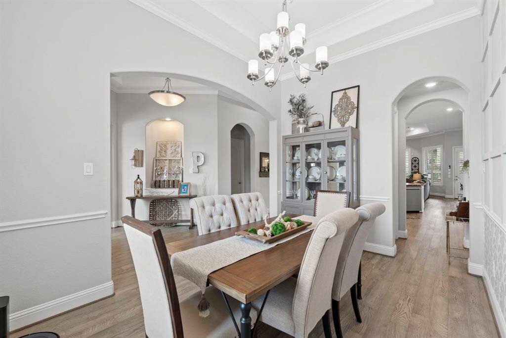 Perfect for entertaining or intimate dinners, this space blends timeless elegance with modern design. Offering tray ceiling and crown molding.