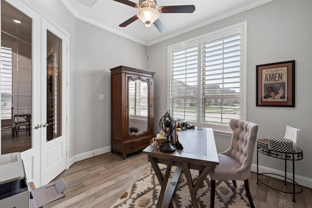 Office space featuring recessed canned lighting, elegant crown molding, and large windows that flood the space with natural light, this office offers the perfect balance of functionality and charm. Whether you're working from home or need a quiet retreat, this space is sure to impress.