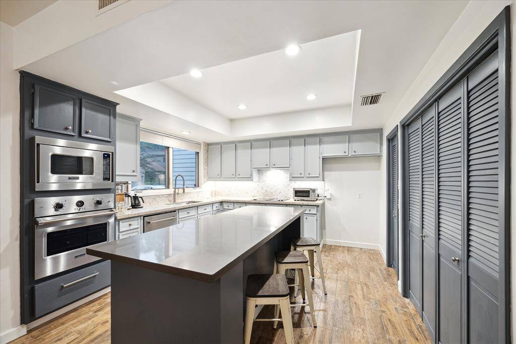 Kitchen features stainless-steel appliances and a tray ceiling