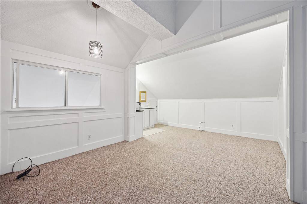 Wet bar with small refrigerator in the wall, above the countertop