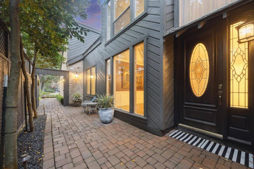 This bricked, side walkway leads to your solid wood, leaded front doors