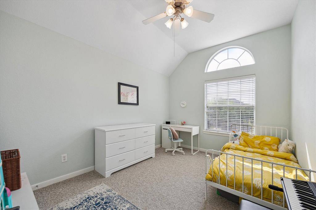 Another large upstairs bedroom, ceiling fan, and 2 inch blinds.