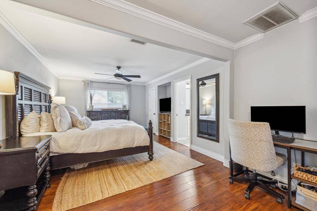 Primary bedroom is graciously sized and has additional space for a desk area or seating.