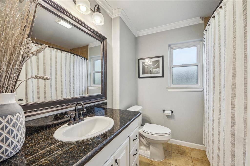 Secondary bath with shower/tub combo.