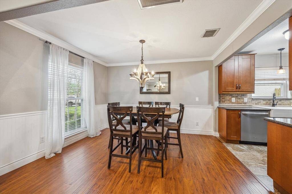 Dining area with attractive light fixture at the end of the front living area.