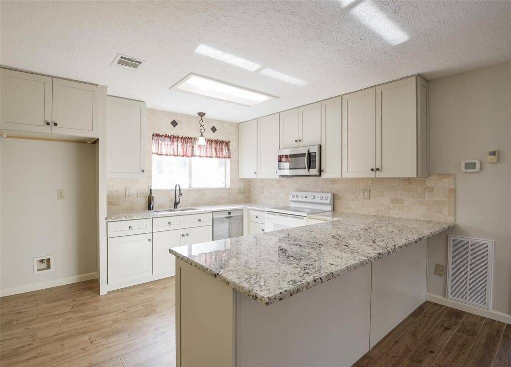Updated Kitchen Features Granite Counter Tops, New Cabinets, Soft Close Doors & Drawers.
